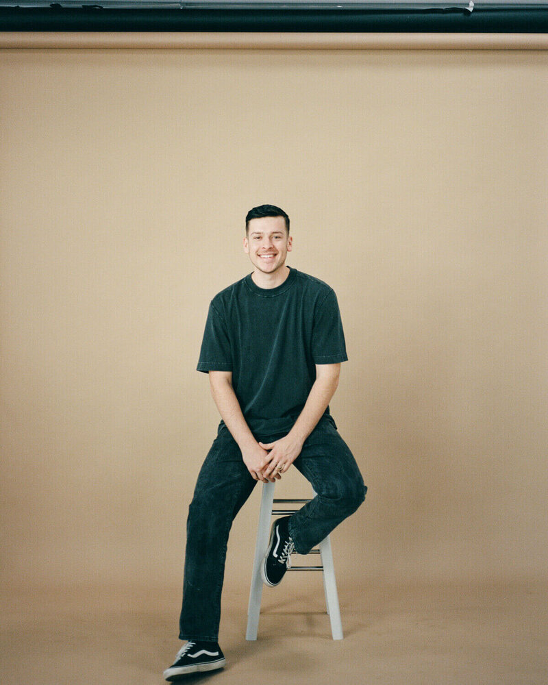 miami florida wedding videographer kowan sitting on stool