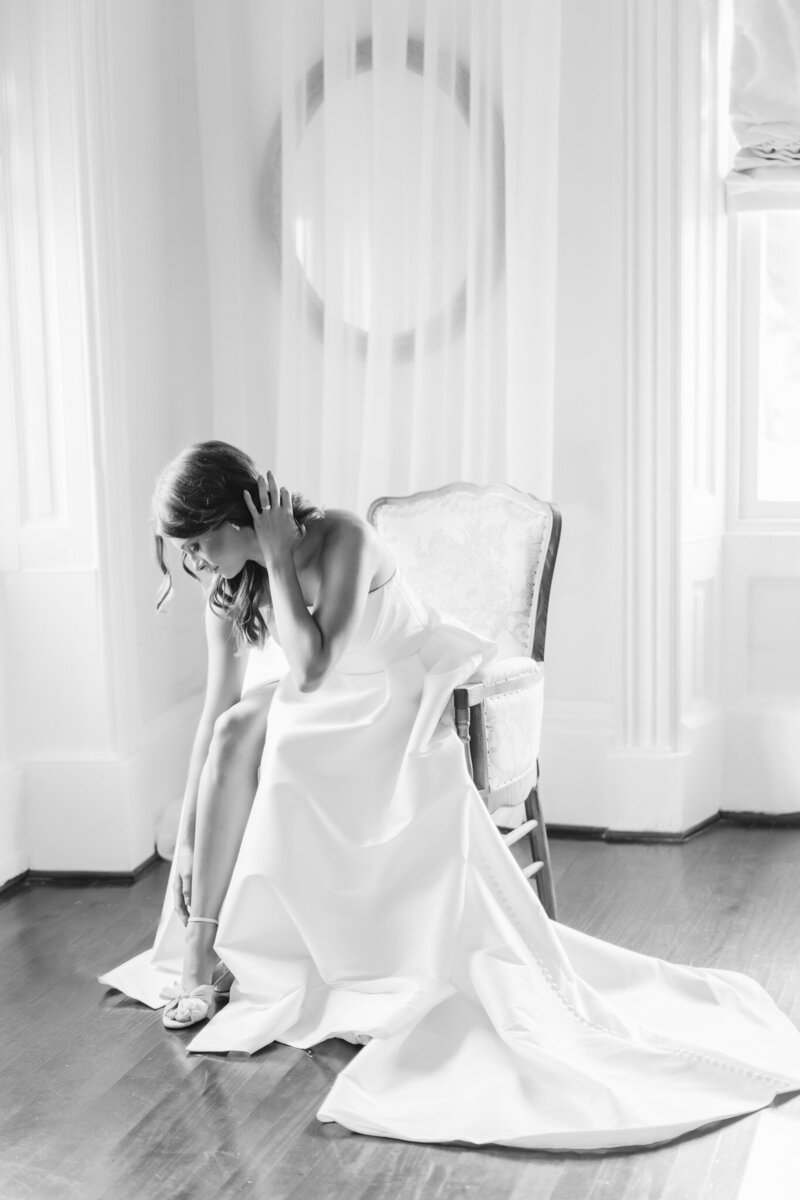 a Lady in Lace bride adjusting her shoe at Drish House