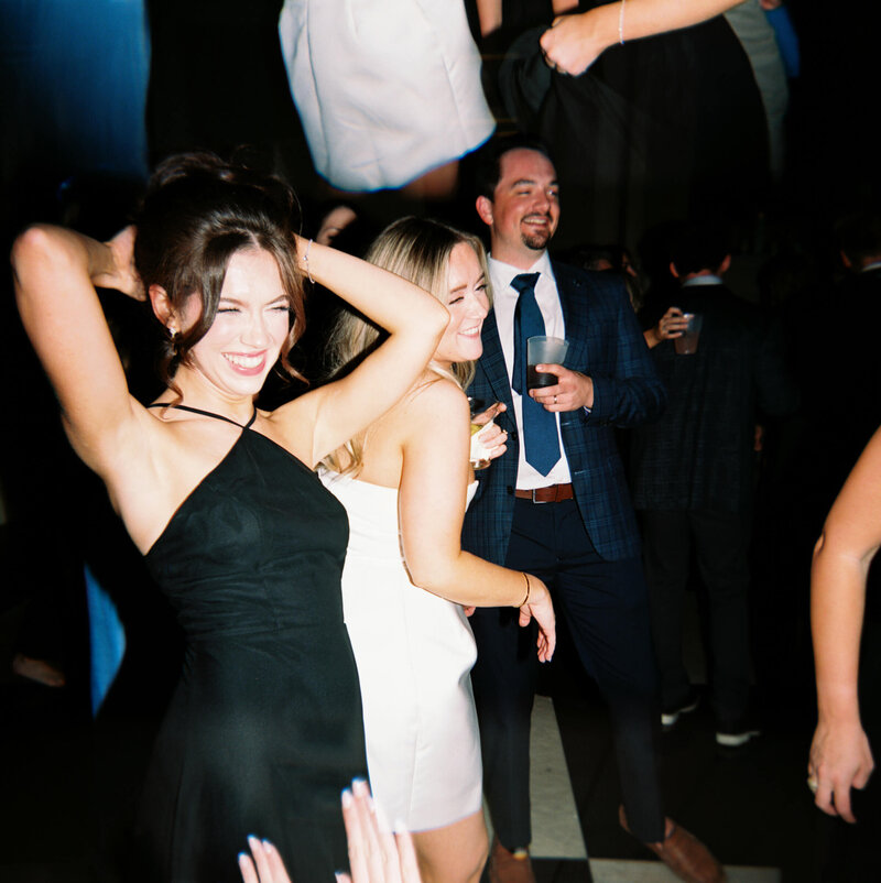A wedding day photo of the bride dancing during her wedding reception