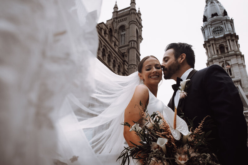 A sample image from Philadelphia wedding photographer Daring Romantics. A couple at City Hall.