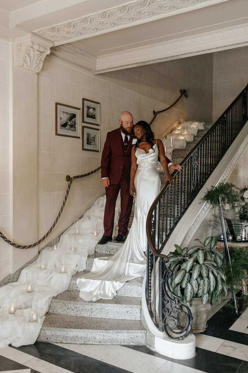 bride and groom on the staircase at the mansion at woodward park in tulsa oklahoma