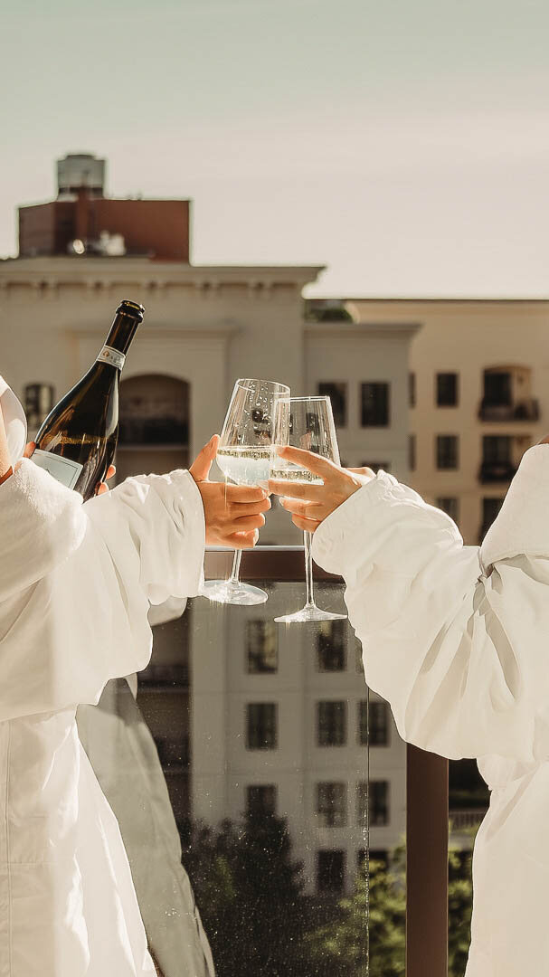 Rooftop celebration representing discovery of each traveler's unique oasis vision. Tailored Oasis Travel Co.