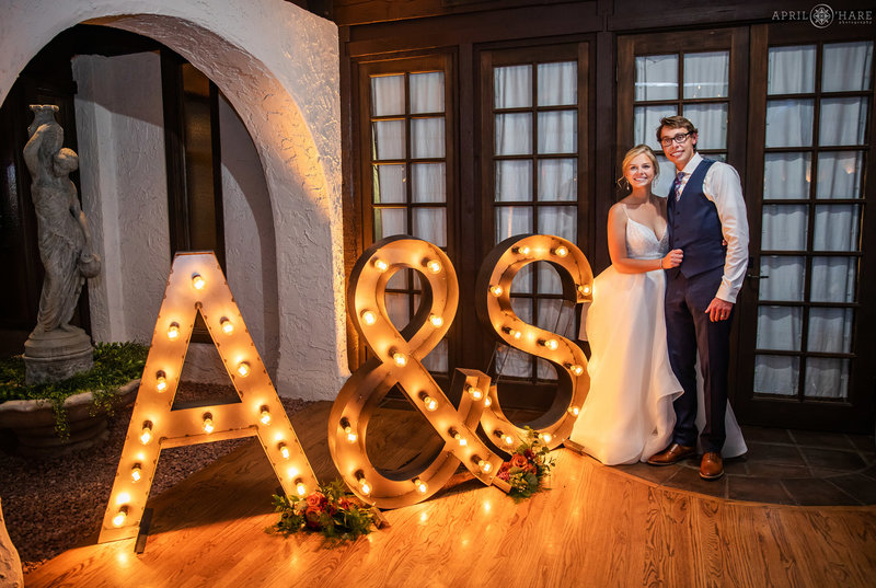 Indoor wedding reception space at Villa Parker with large industrial style lit letter decor