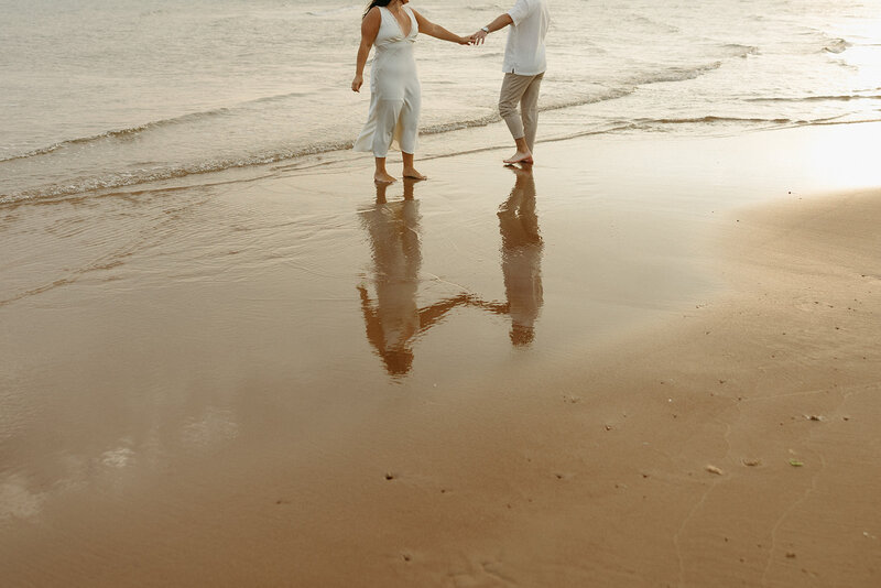 couple embracing on beach for lifestyle photos in pei