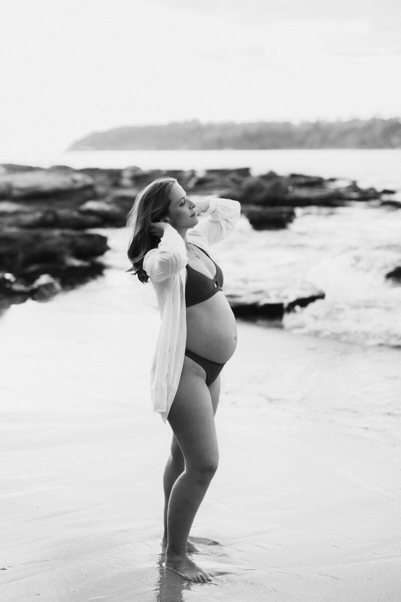 Pregnant woman posing for pregnancy photoshoot at Sydney beach 