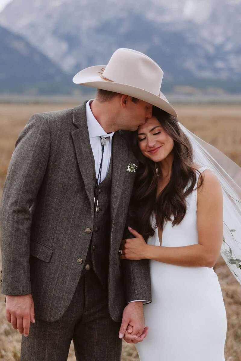 A couple looking into each others eyes laughing in the Sawtooth mountains in Stanley, Idaho