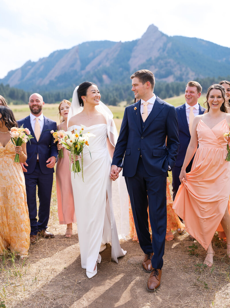 a black bride looking down at her white flowers by colorado wedding photographer jkg photography