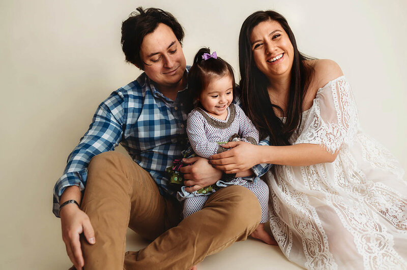 Family Poses with their Infant during Newborn Photoshoot in Asheville, NC.