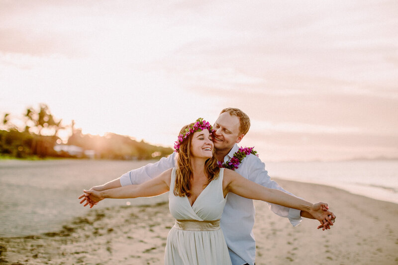 couple with arms stretched on beach