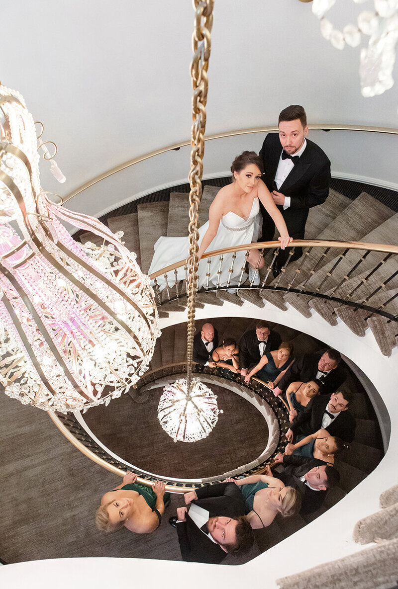 Ally and Sean's wedding was the epitome of glamor and class. Ally looked like a queen in her elegant, high fashion wedding gown and Sean could have walked out of the pages of GQ in his tuxedo. So when we saw this marvelous spiral staircase and chandeliers, the bridal party slipped into their vogue poses naturally.
