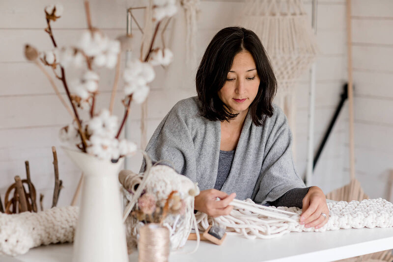 Isabella Strambio surrounded by macrame cord in her studio