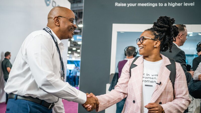 Alesia Hendley hand shaking a man in a event