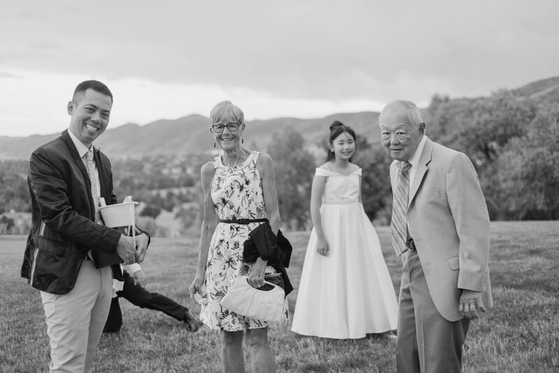 family gathered during cocktail hour at wedding at the manor house in littleton colorado