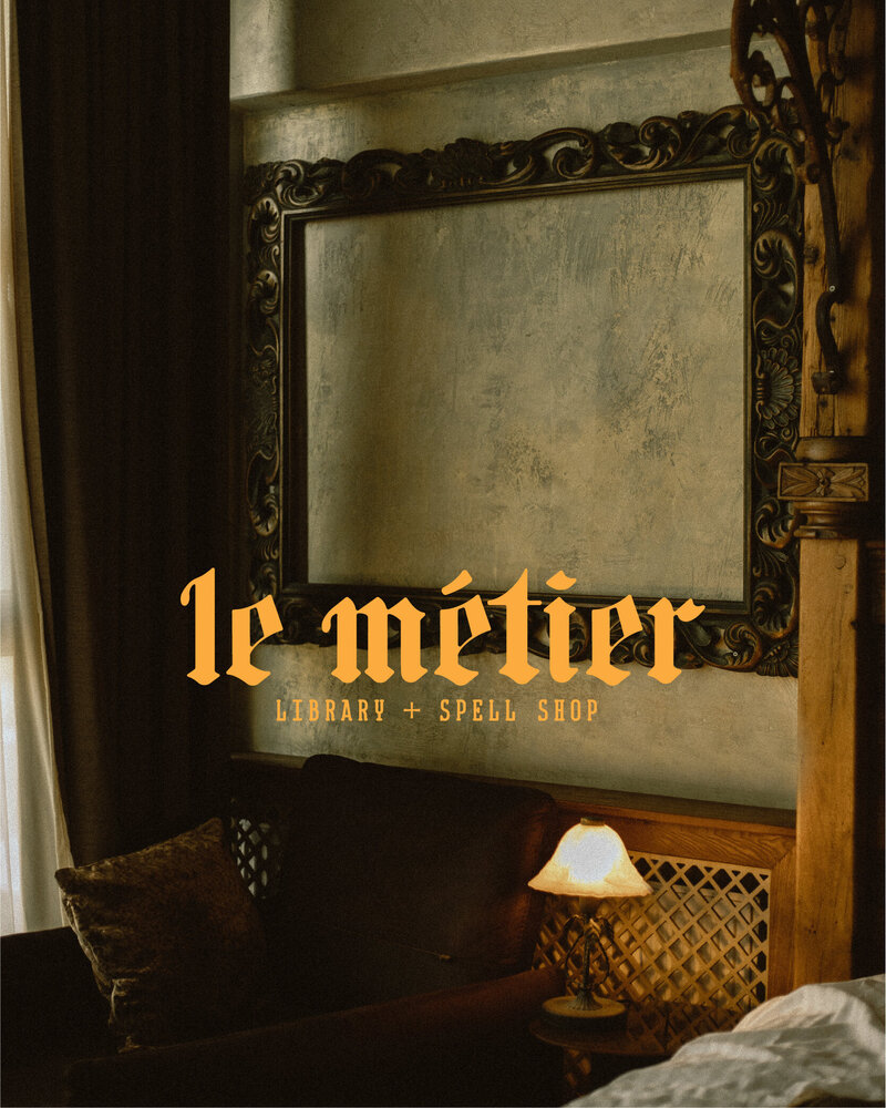 dark academia style sitting room with le metier library and spell shop main logo