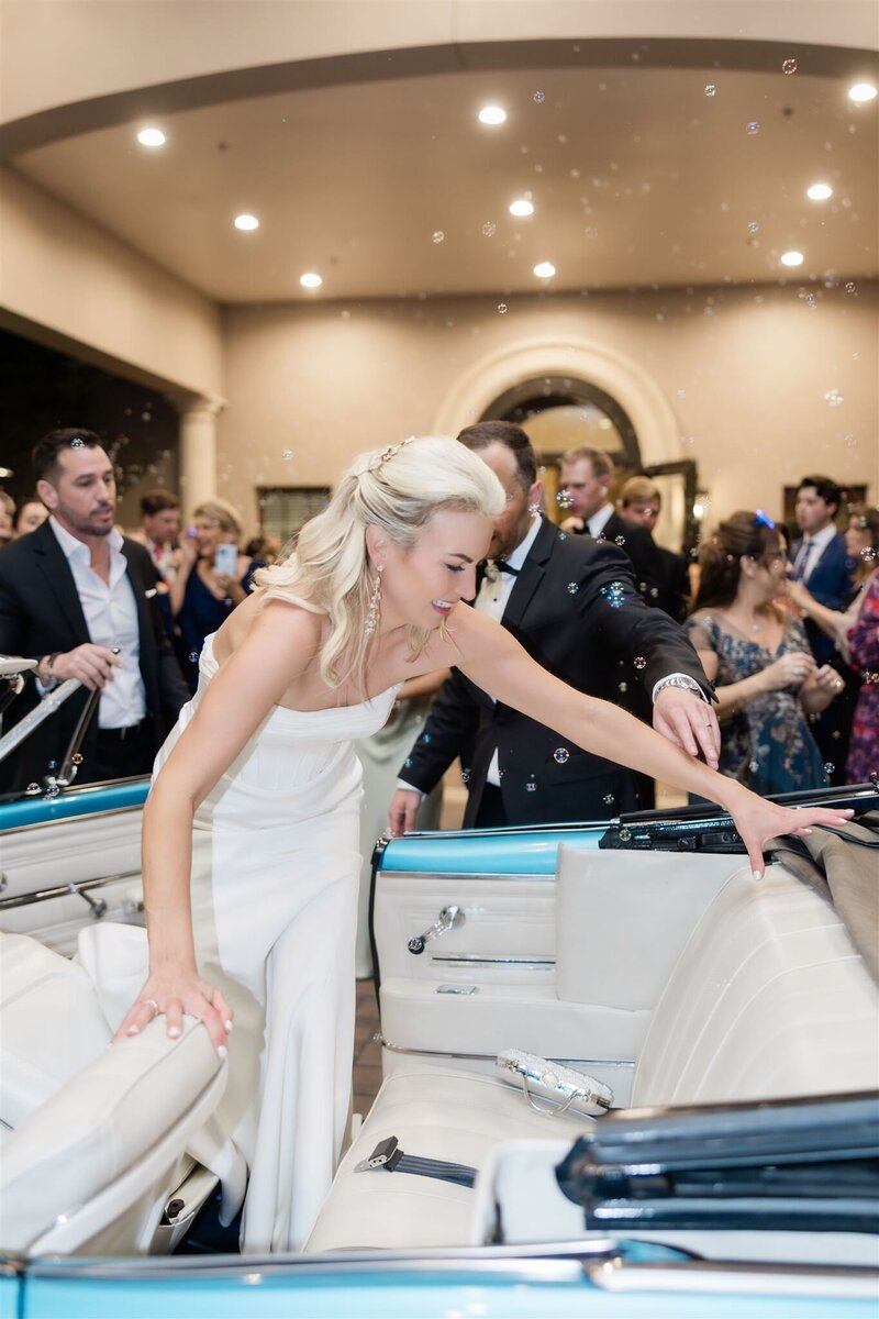 Wedding reception getaway car at the country club of Orlando by orlando wedding photographer 