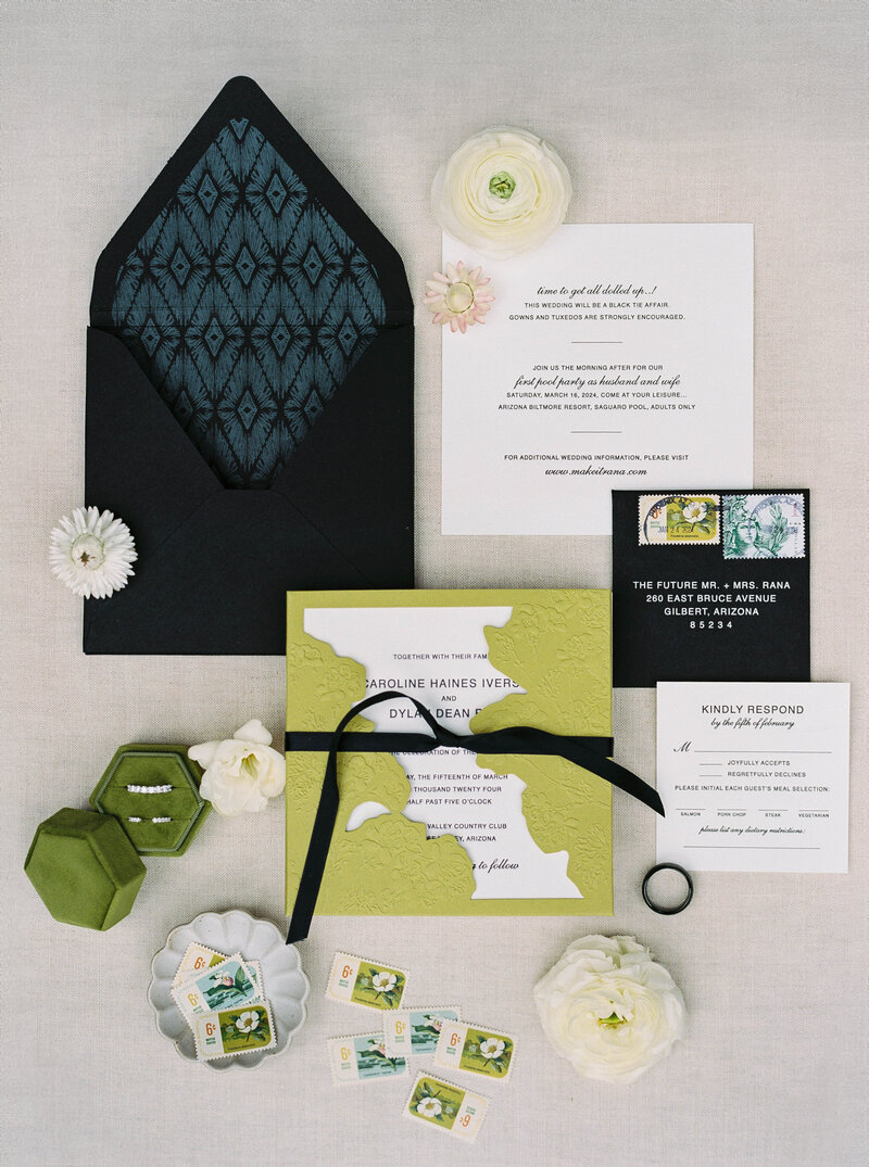 Luxury wedding photographer capturing elegant wedding invitations with a black, green, and white aesthetic, styled for a fine art wedding.