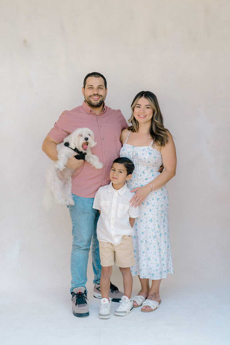 Family posing with pet dog