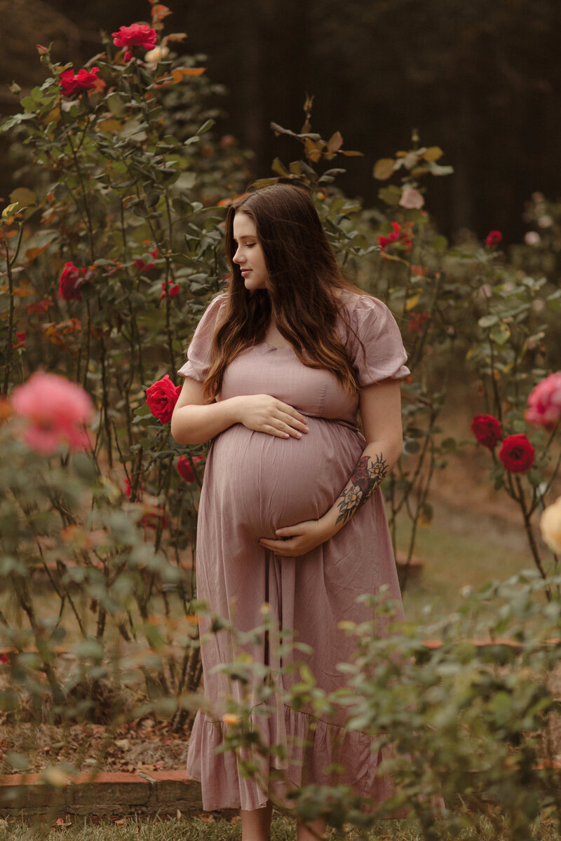 Pregnant mama in smocked Shein dress in the rose garden by Atlanta Maternity Photographer.
