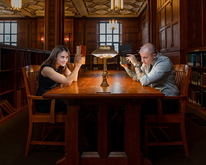 An engaged couple sharing a quiet, heartfelt moment while reading books together in a cozy library in Lehigh Valley during their engagement session.