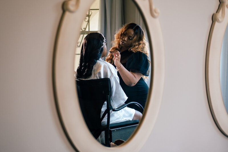 black bridal makeup artist holding pink mug that says hello gorgeous