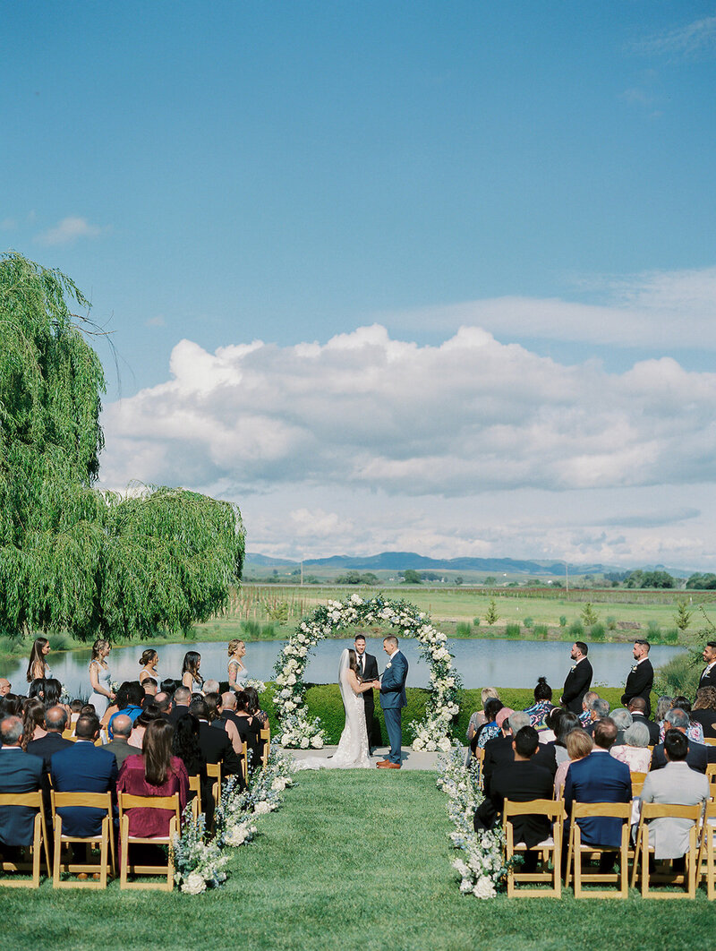 Romantic wedding with a couple exchanging vows during a beautiful outdoor ceremony.