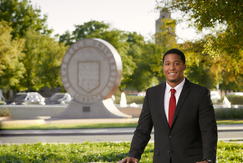 Collge graduate on Texas Tech campus by CjDuncan Photography