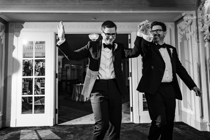 Grooms make their entrance during their wedding reception at at The Blackstone in Chicago, IL