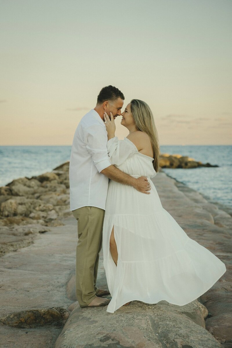 couple embraces on the beach in south florida for couples portraits