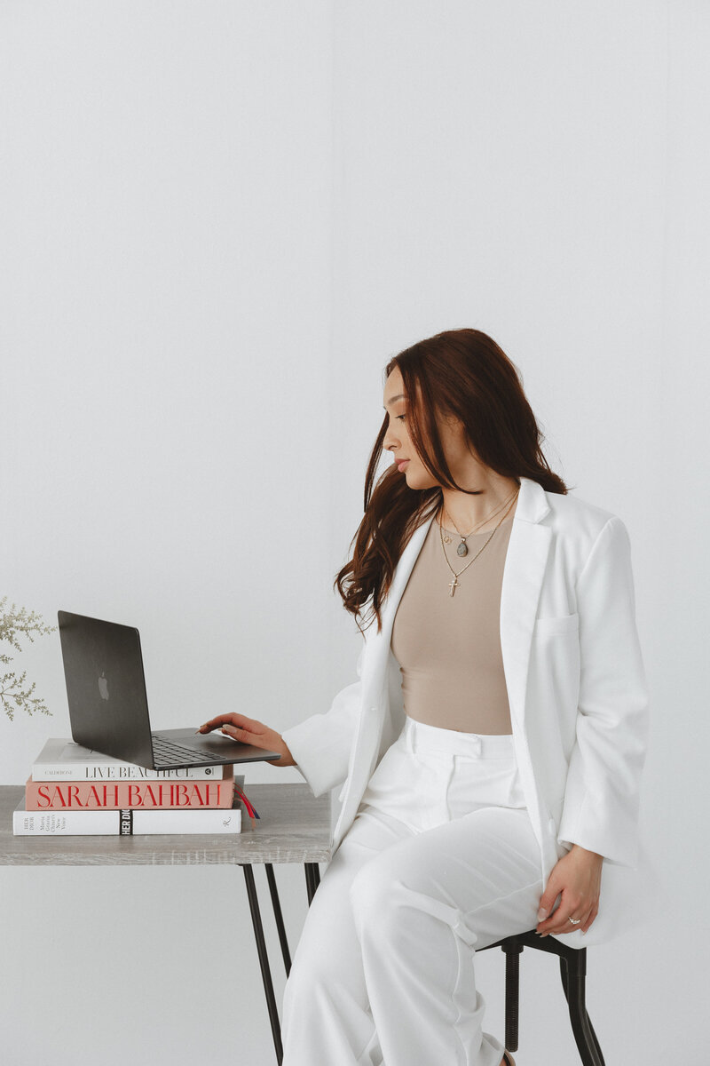 The founder of House of Virtua Mind, focused at work on a laptop in a modern office setting