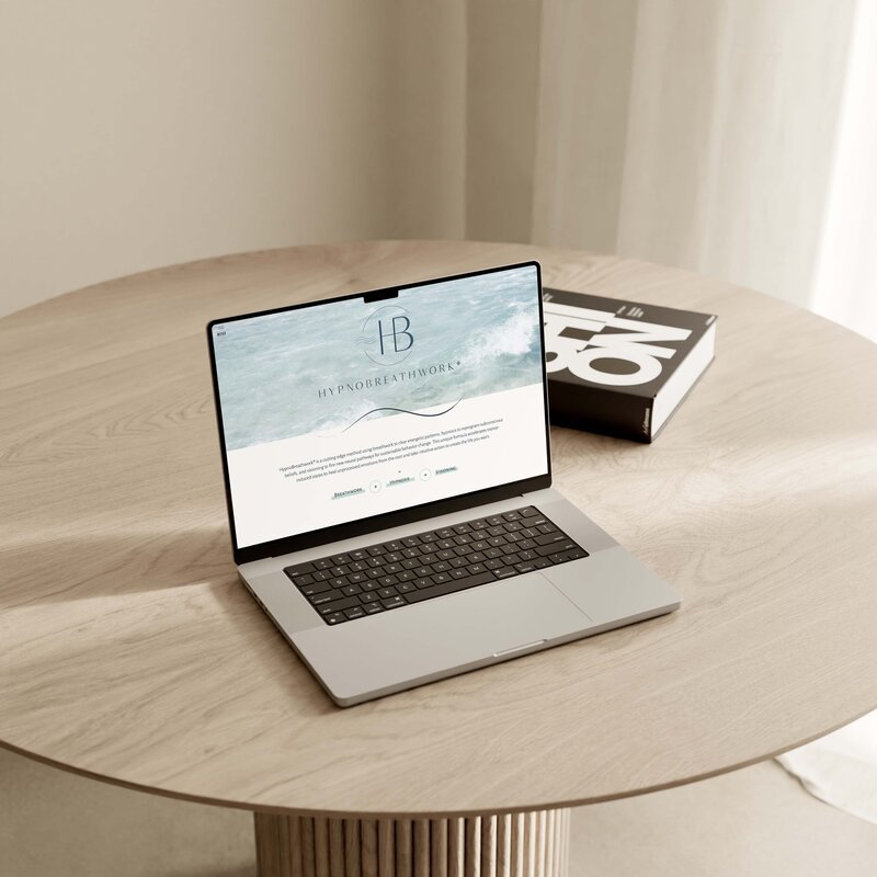 MacBook with open website in browser on a desk
