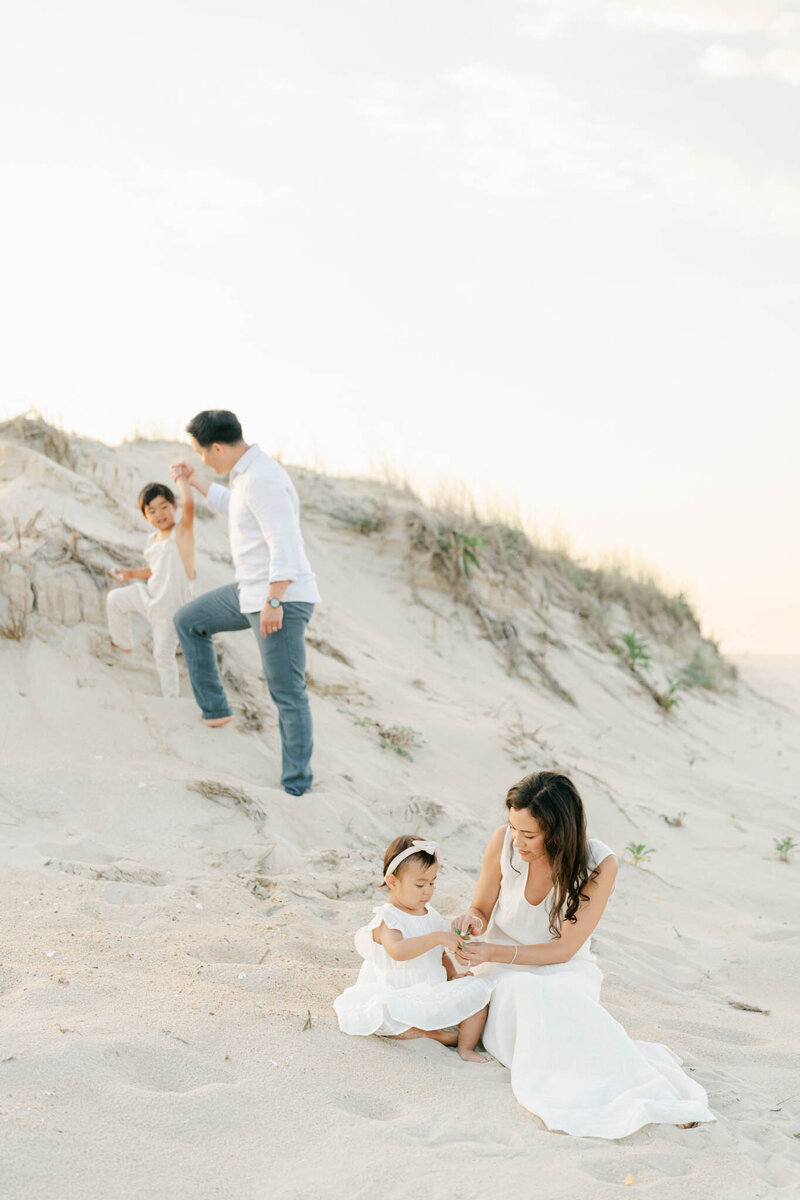 family of five plays during a photo session with AnneMarie Hamant
