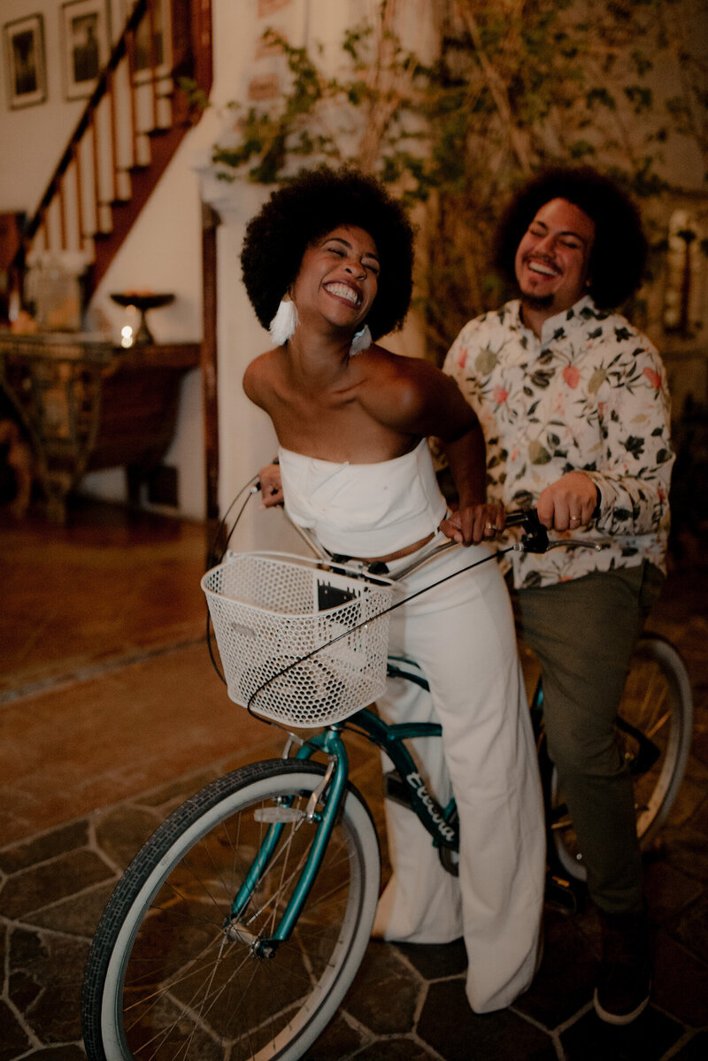 Bride and groom pose on a bike at Korakia pensione in Palm Springs during an elopement
