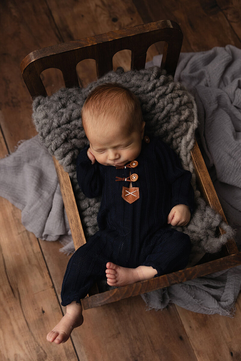 Newborn boy sleeping in a navy sleeper for his Pittsburgh newborn session.