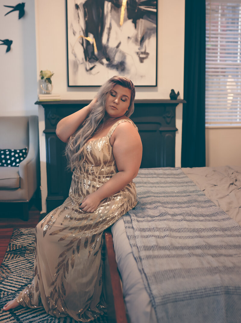 plus sized portrait of woman wearing a glamourous gold sequin gown