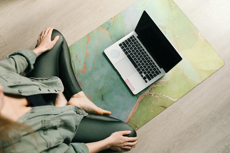 Woman logging into a Supported Awakening activation class from Europe using a computer for virtual session