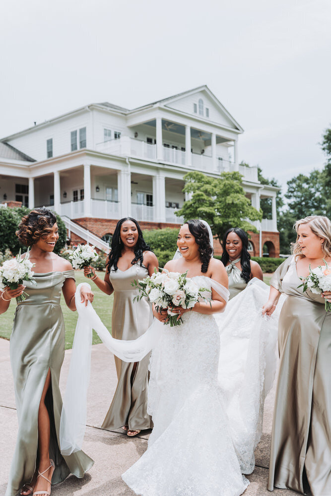 bride and bridesmaids laugh while walking