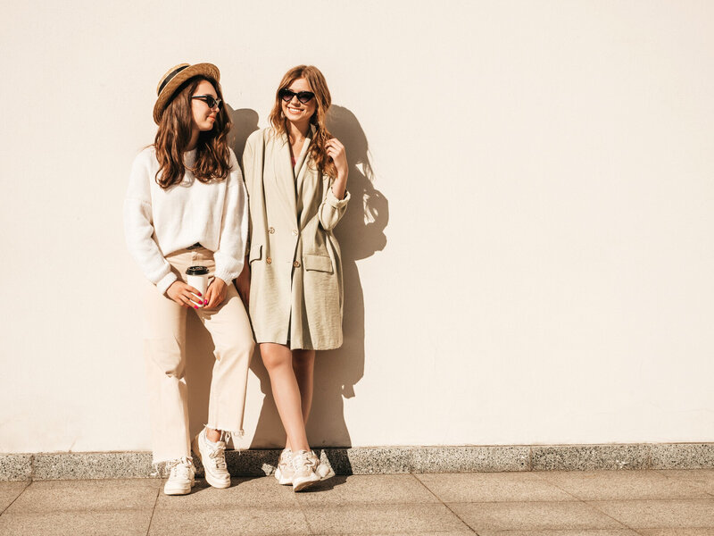 two-young-beautiful-smiling-hipster-female-trendy-white-sweater-coat