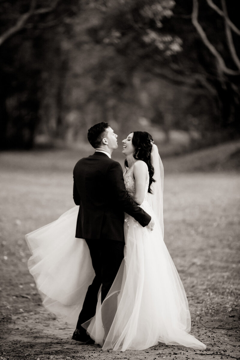 Wedding couple laughing as they get close to each other