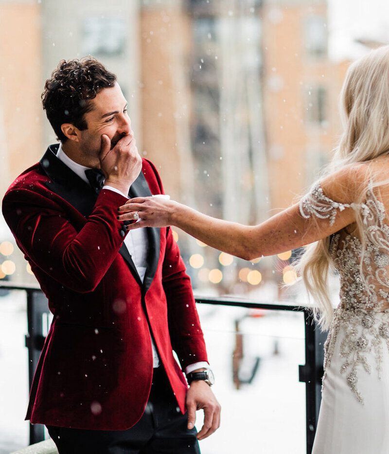 A groom gasps in surprise as he sees his bride for the first time on their winter wedding day in Jackson Hole
