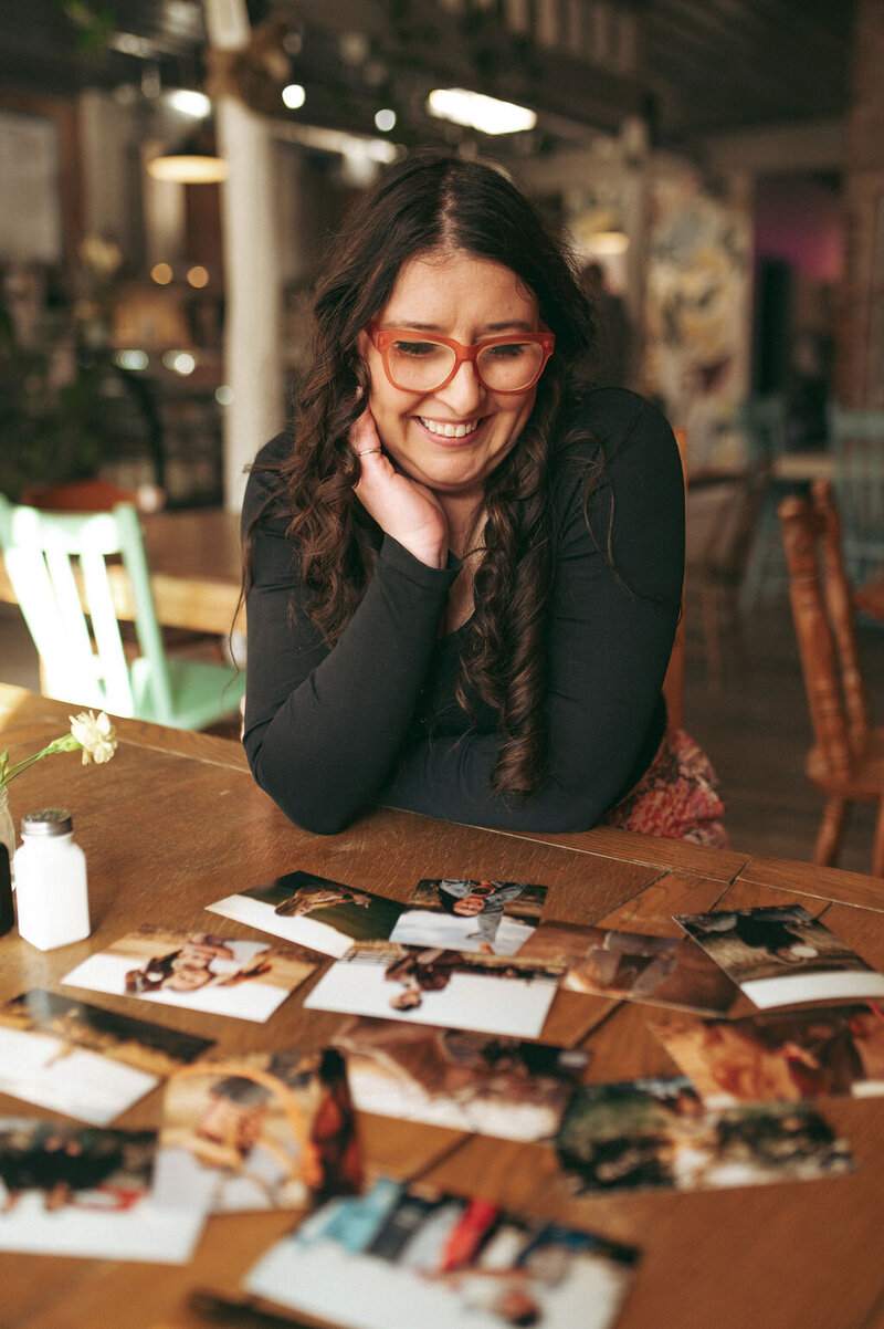 Brand photographer looking at images she took on a coffee table 