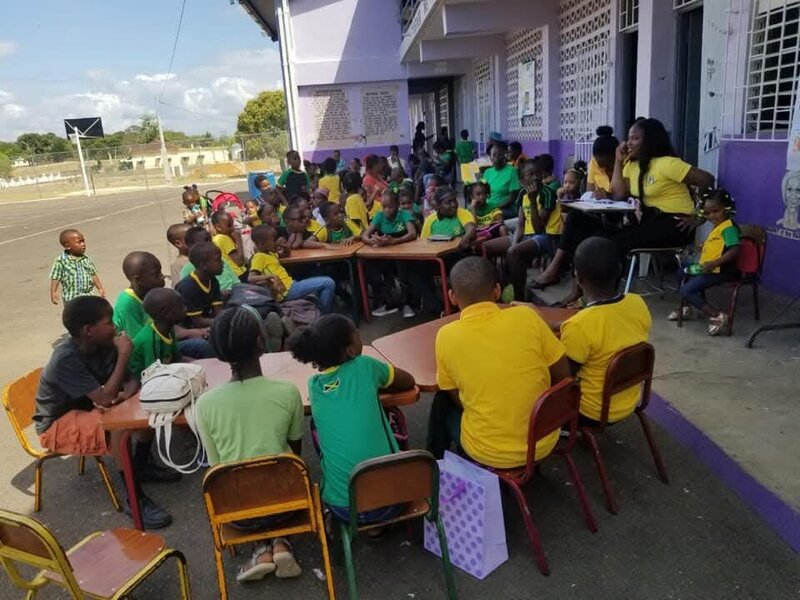Students and teachers gathered outside Barbary Hall Primary and Infant School during a community activity before Hurricane Melissa.