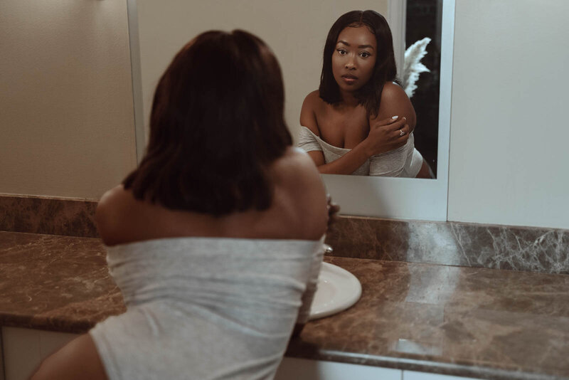 Woman posing in white dress shirt for boudoir portrait