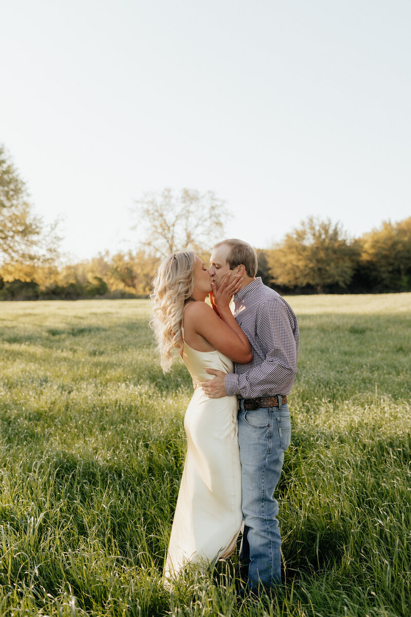 Couple kissing under tree