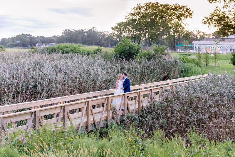Gorgeous wedding photo on a bridge over the water in Hampton Roads Virginia by Mattie Wezah Photography