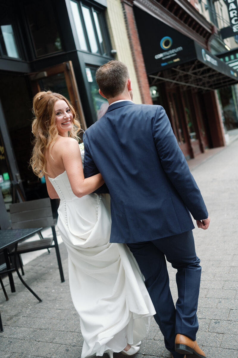 A bride with a serene expression poses in a soft, elegant gown, showcasing timeless bridal beauty.