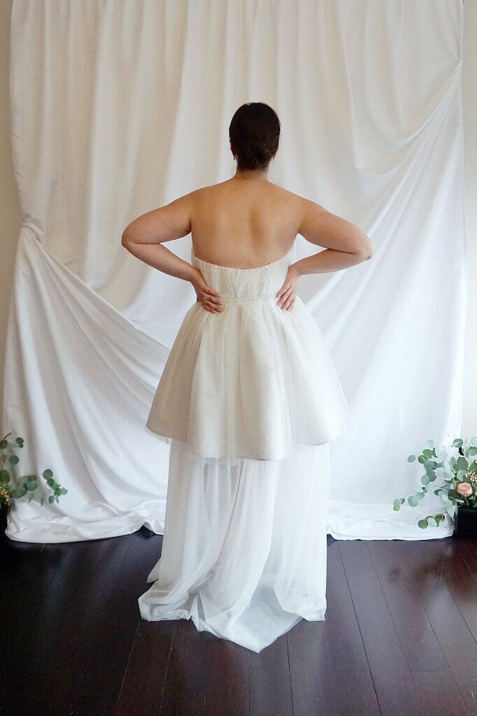 Back view of strapless tulle wedding dress with belt
