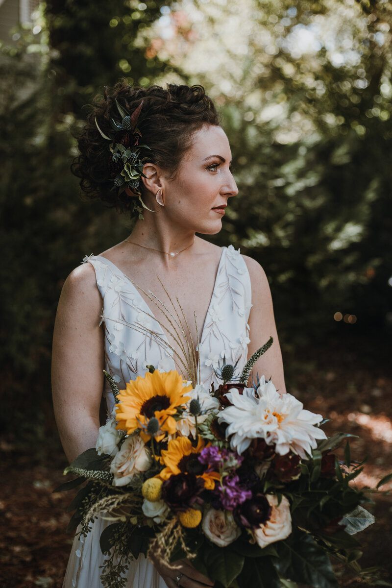 bride in garden holding flowers