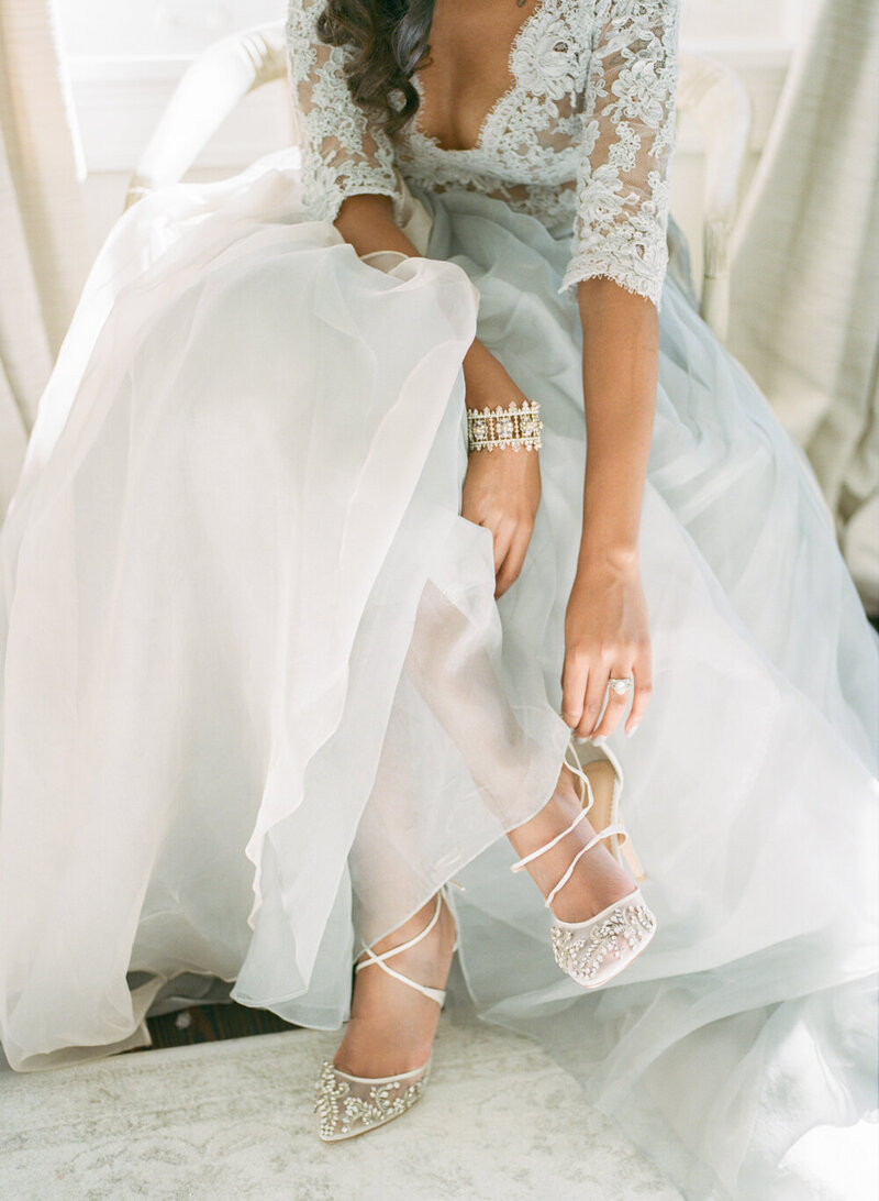luxury bride putting on wedding shoes