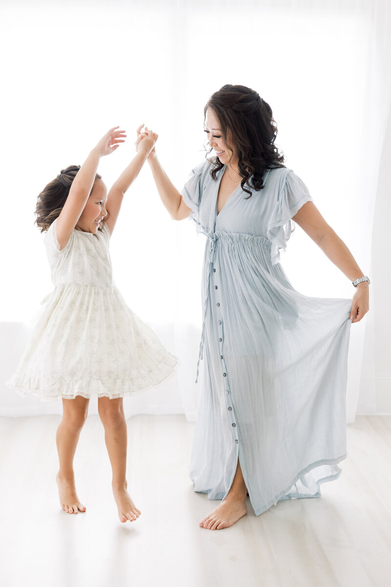 a mom dancing with her young daughter