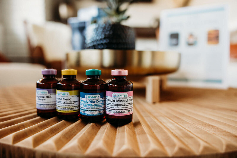 Four IV vials sitting on a wood table